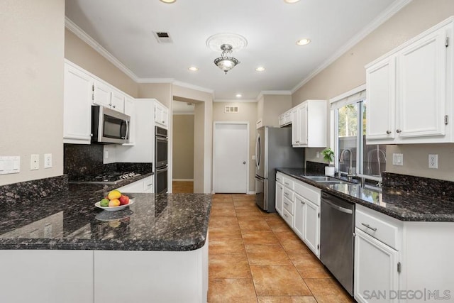 kitchen featuring sink, light tile patterned floors, appliances with stainless steel finishes, dark stone countertops, and white cabinets