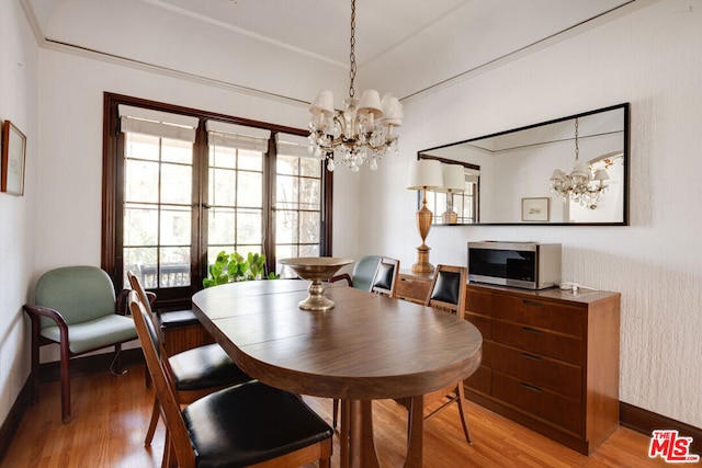 dining room featuring hardwood / wood-style flooring and a notable chandelier