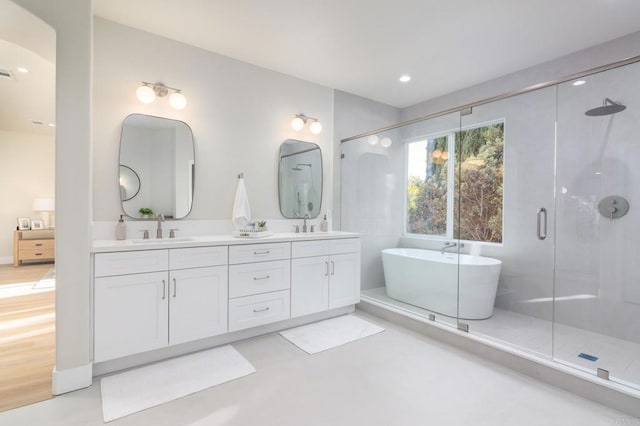 bathroom featuring vanity and plus walk in shower