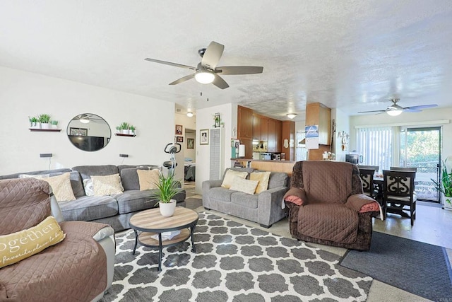 living room featuring a textured ceiling and ceiling fan