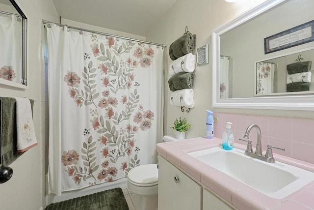 bathroom with tile patterned flooring, vanity, backsplash, toilet, and walk in shower