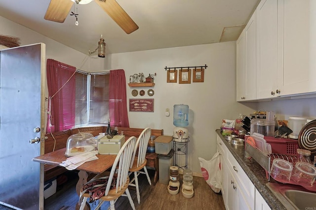 dining room with ceiling fan and dark hardwood / wood-style flooring