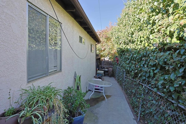 view of side of home with a patio