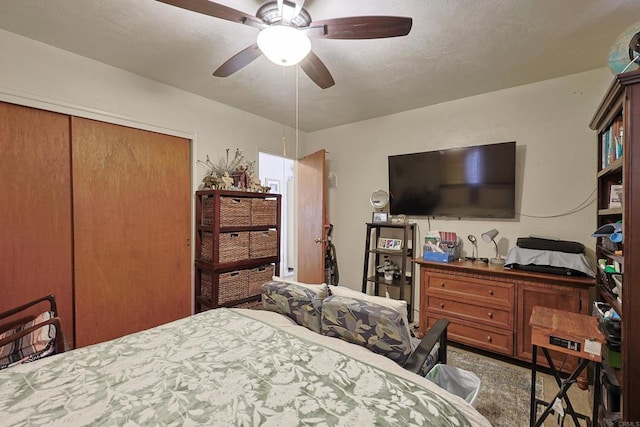 bedroom with ceiling fan and a closet