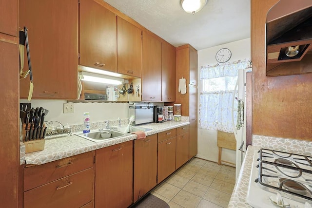 kitchen with stovetop and light tile patterned floors