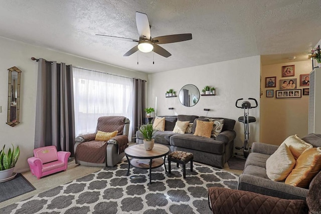 carpeted living room with ceiling fan and a textured ceiling