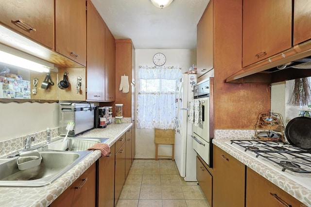 kitchen with sink, white appliances, and tasteful backsplash