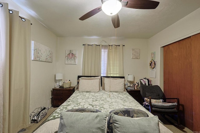 bedroom with ceiling fan and a closet