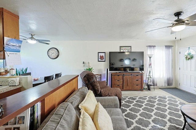 carpeted living room with a textured ceiling and ceiling fan