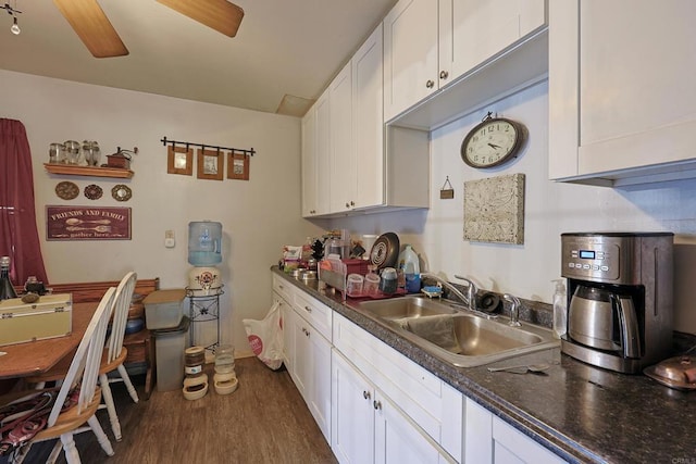 kitchen with sink, white cabinets, dark wood-type flooring, and ceiling fan