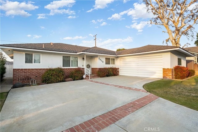 single story home with a garage and a front lawn