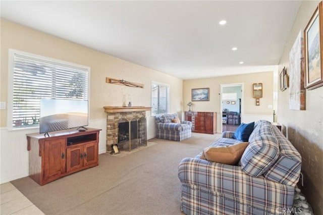 carpeted living room featuring a fireplace