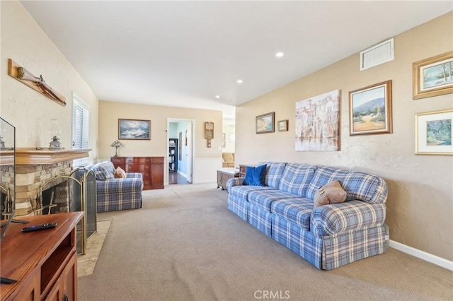 living room with light carpet and a fireplace