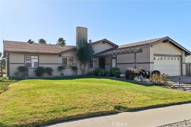 ranch-style home with a garage and a front lawn