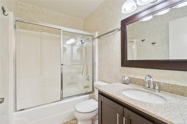 full bathroom with vanity, shower / bath combination with glass door, and toilet