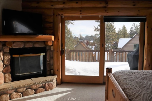 doorway to outside featuring light carpet and a stone fireplace