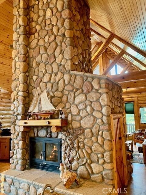 details with a fireplace, wood finished floors, wood ceiling, beamed ceiling, and rustic walls