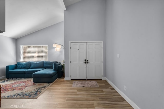 entryway with light hardwood / wood-style flooring and lofted ceiling