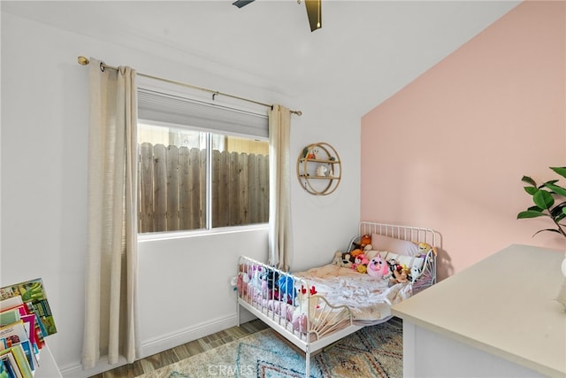 bedroom with ceiling fan and hardwood / wood-style flooring