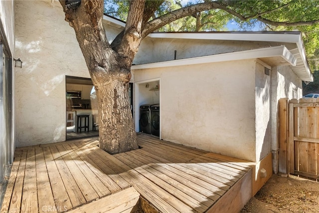 wooden deck featuring independent washer and dryer