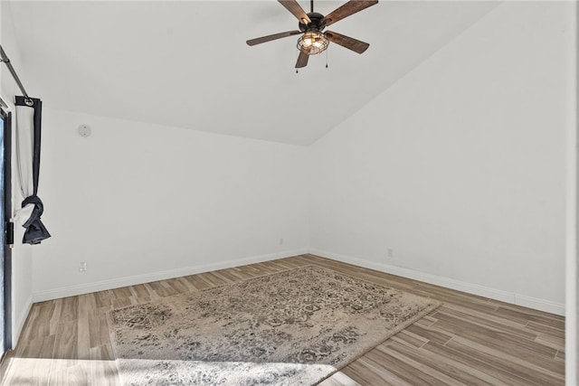 unfurnished room featuring light wood-type flooring, vaulted ceiling, and ceiling fan