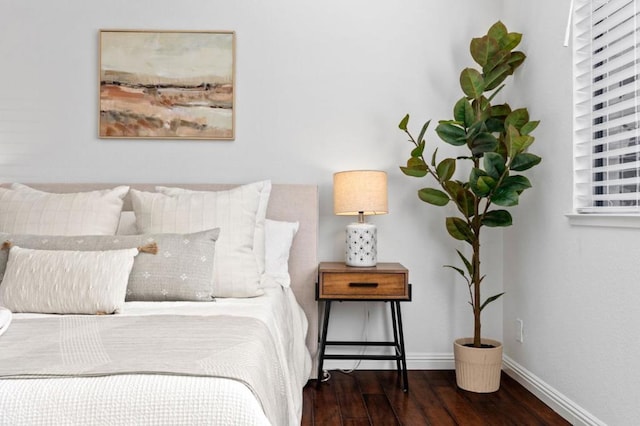 bedroom with dark wood-type flooring