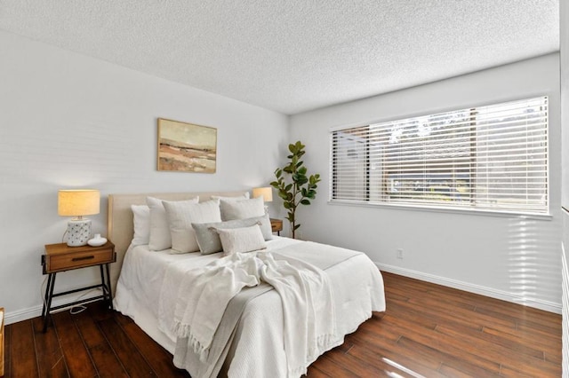 bedroom with dark wood-type flooring and a textured ceiling