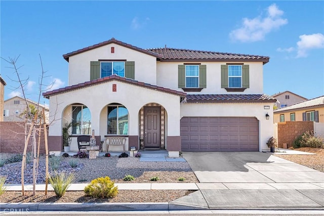 mediterranean / spanish-style home with a porch and a garage