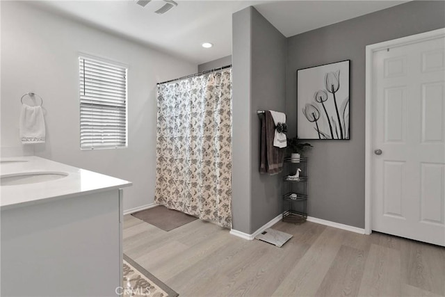 bathroom featuring hardwood / wood-style flooring, a shower with shower curtain, and vanity