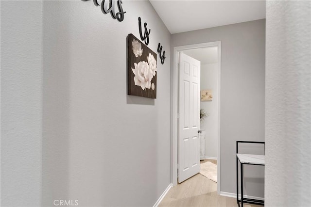 hallway with light hardwood / wood-style flooring