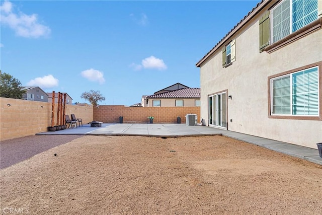 view of yard featuring a patio area, a fire pit, and central AC