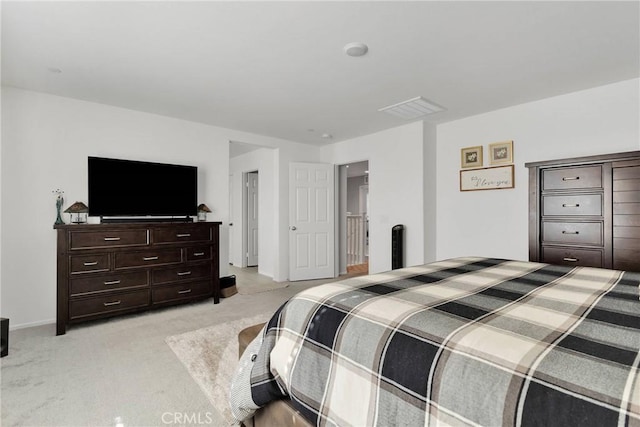 bedroom featuring light colored carpet