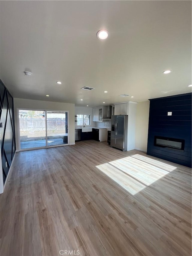 unfurnished living room featuring light wood-type flooring