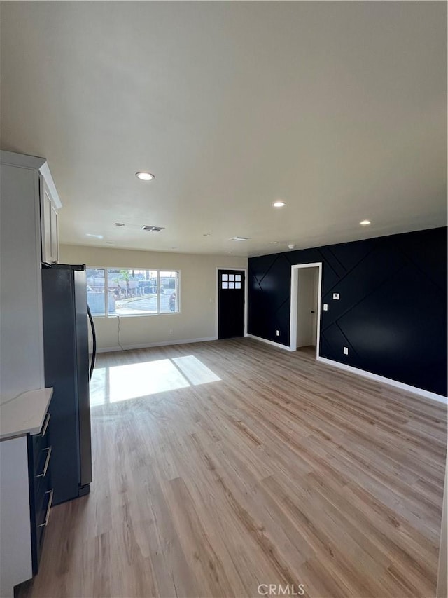 unfurnished living room with light wood-type flooring