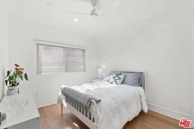 bedroom featuring crown molding, light wood-type flooring, and ceiling fan