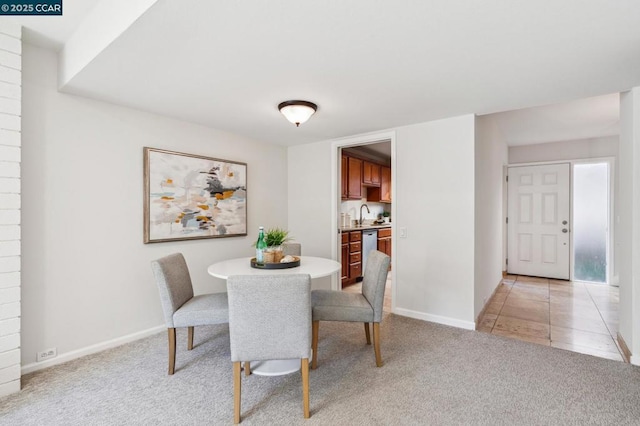 carpeted dining area featuring sink