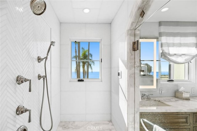 bathroom featuring vanity and a tile shower