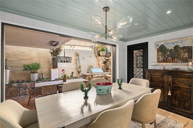 dining space with wooden ceiling and light wood-type flooring