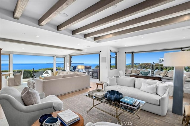 living room featuring a water view, beamed ceiling, and light hardwood / wood-style flooring