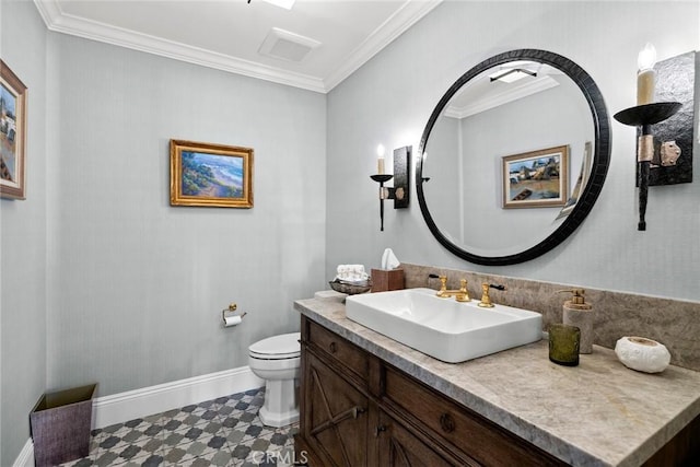 bathroom with vanity, toilet, and ornamental molding