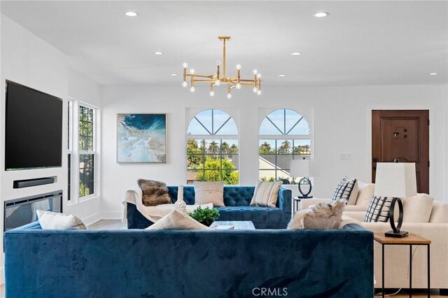 living room featuring a chandelier and a healthy amount of sunlight