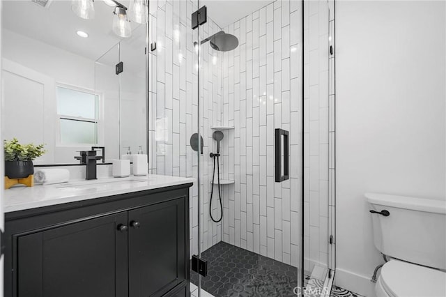 bathroom with toilet, walk in shower, and vanity