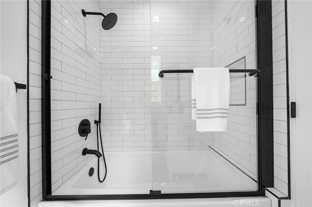 bathroom with shower / bath combination with glass door