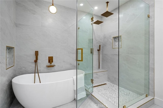 bathroom featuring tile walls and plus walk in shower