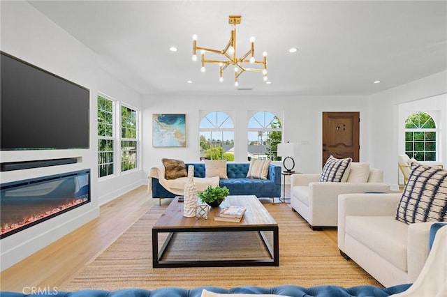 living room featuring light wood-type flooring and an inviting chandelier