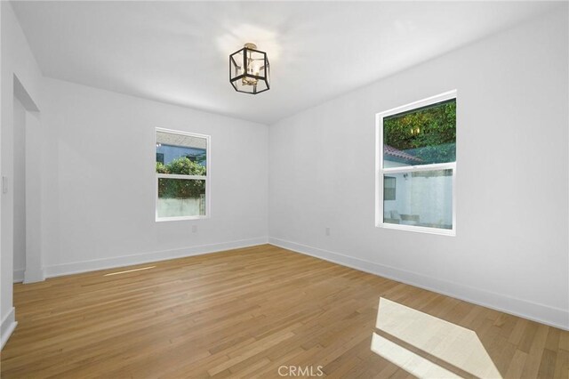 empty room with a healthy amount of sunlight and light wood-type flooring