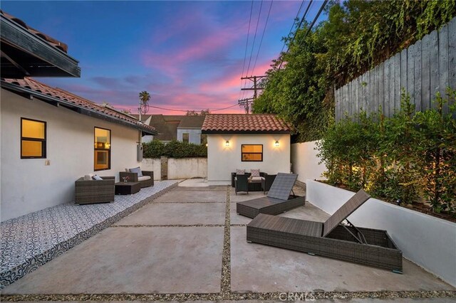 patio terrace at dusk with an outbuilding and an outdoor living space