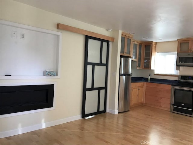 kitchen featuring appliances with stainless steel finishes and light wood-type flooring