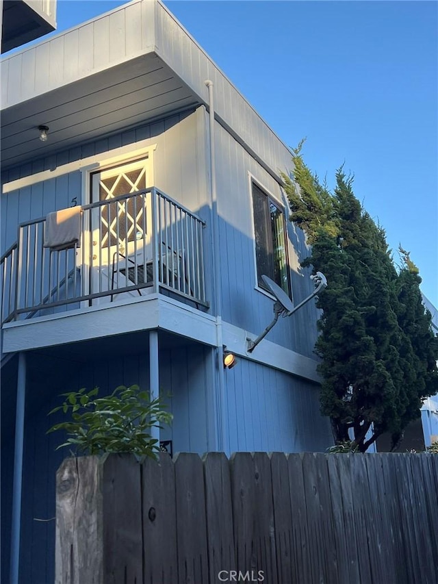 view of side of home featuring a balcony