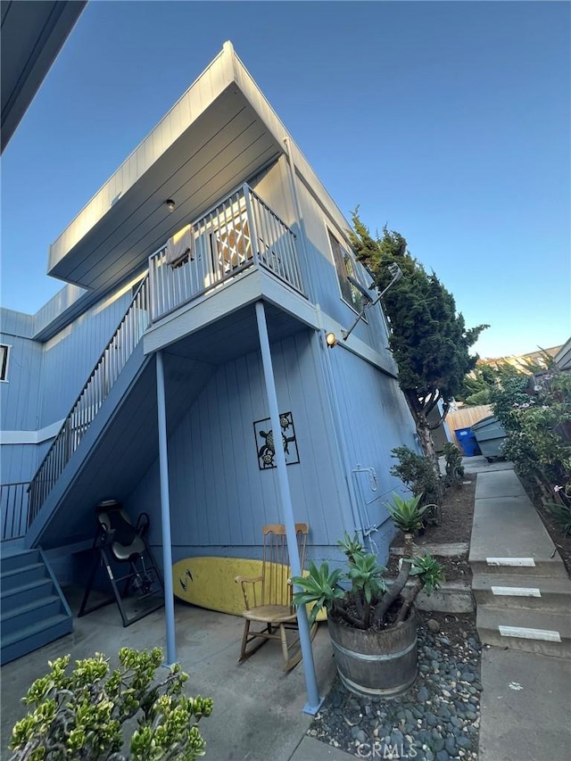 view of property exterior featuring a balcony and a patio area